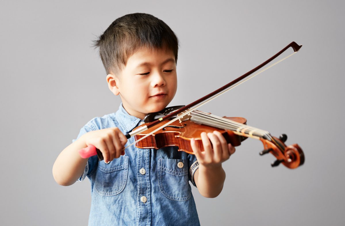 Beginners Young boy learning to play the violin